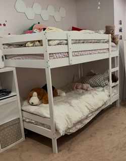 The white IKEA MYDAL Bunk bed frame is a solid pine twin-over-twin space-saving solution featuring a fixed vertical ladder