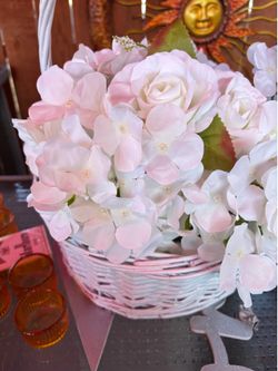 White basket and artificial flowers