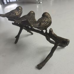 Bronze Birds Perched On A Branch