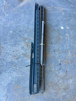 A bundle of Edsal steel shelving upright posts and beam channels