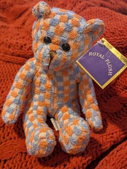 Royal Plush brand teddy bear featuring a distinctive orange and blue checkered fabric pattern.