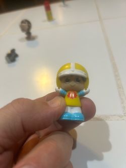 Fisher-Price Little People character, specifically resembling Eddie the Snowboarder or a similar athletic figure