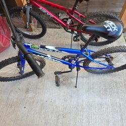 Huffy Blue And Next Red Bike