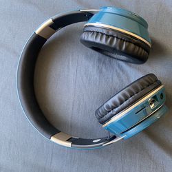 Two pairs of brand-new, unused wireless on-ear headphones. First pair: sleek black-and-red design with a bold, premium feel. Inspired by high-end bran