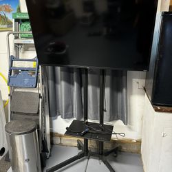 Roku Tv 50” And Rolling Stand Perfect Condition