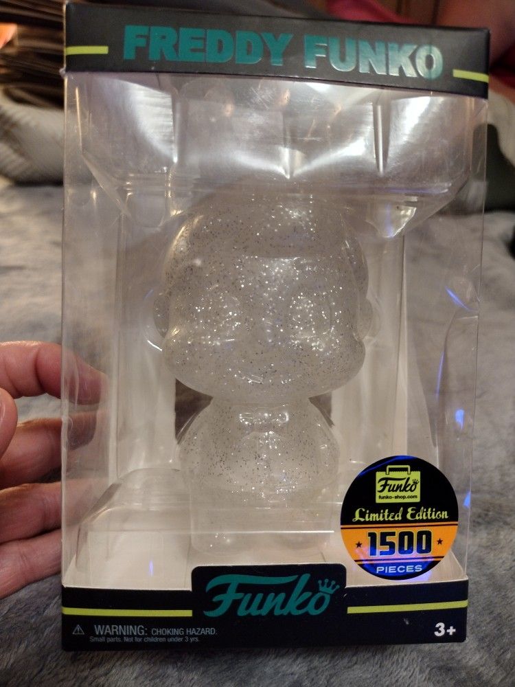 Freddy Funko Hikari vinyl figure, specifically the clear version with silver glitter.