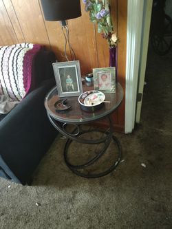 Two circular glass top end tables