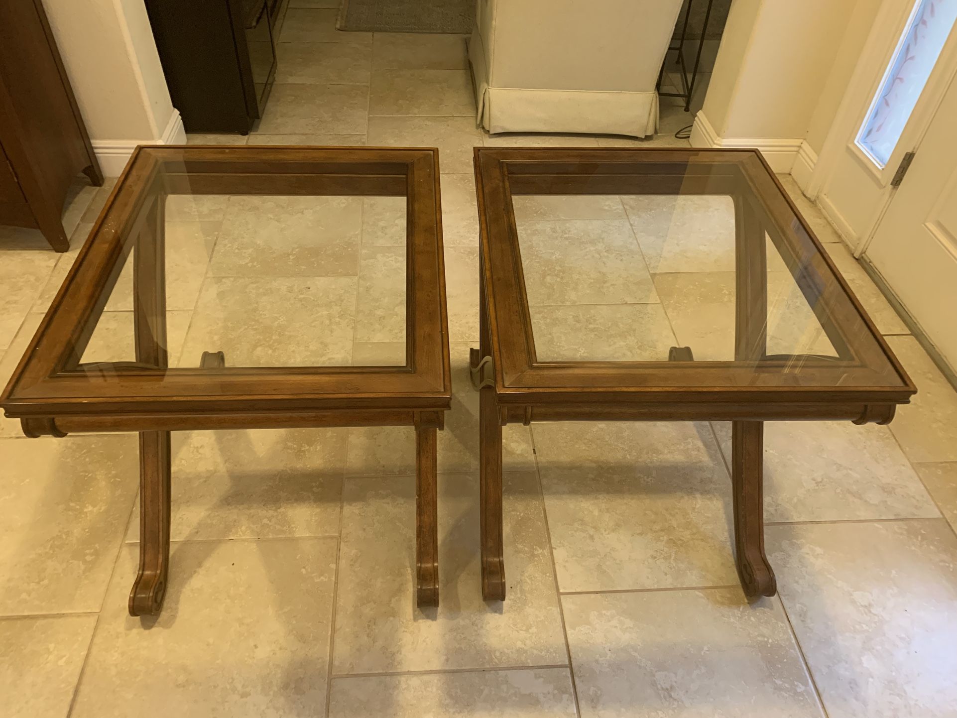 Two wooden glass top beveled end tables. 24 x 28” top and 25.5 inches tall both in excellent condition. $100.