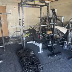 Powertec bench press/squat rack with 7ft 45lbs bar plus 255lbs of rubber coated weights plus curl bar and weights tree