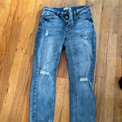 Low rise blue denim jeans with distressed details. Size 3 