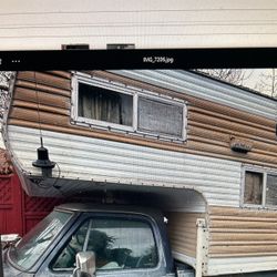 Dodge Pickup with a One Bedroom Camper On Top
