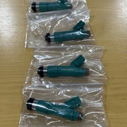 (4) Toyota/Denso Fuel Injector with the part number 230. This specific injector is primarily used in 2.4L I4 (2AZ-FE) engines across various T