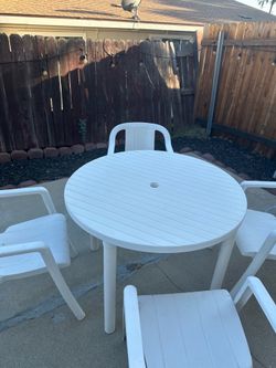 Round plastic table with 4 chairs