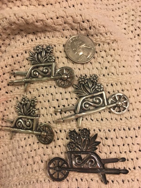 Metal wheelbarrow with flowers , arts and craft , pins , put on the fridge with a magnet . $2.50each . Great for Mother’s Day
