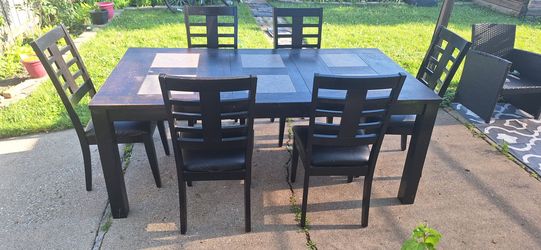 Dinner table with chairs, flyleaf.
