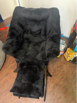 Plush black chair with ottoman