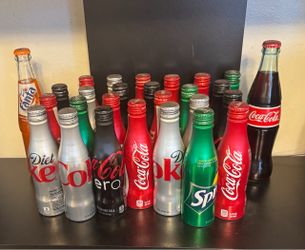 27 collectible bottles from the Coca Cola soft drink company.