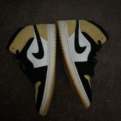Nike Air Jordan 1 Mid in the "Yellow Toe" colorway. 
