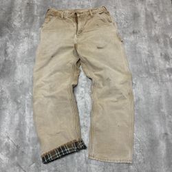 Tan Carhartt pants with plaid lining