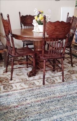 Brown dining table and four chairs