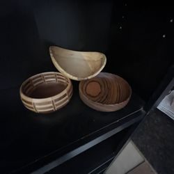 A collection of three contemporary turned wooden bowls.