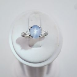 platinum blue grey star sapphire and trillion diamond ring