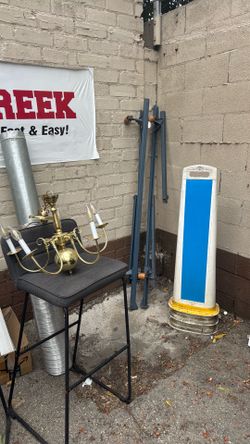 Free stuff. Chandelier, bed, stand frame, parking sign.