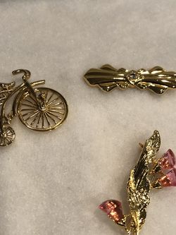 Three Gold Colored Pins
