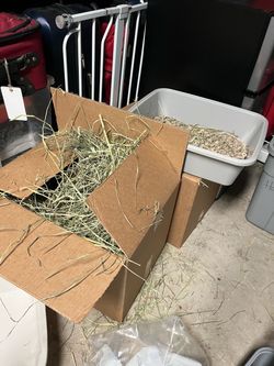 Two boxes mixed hay for rabbits