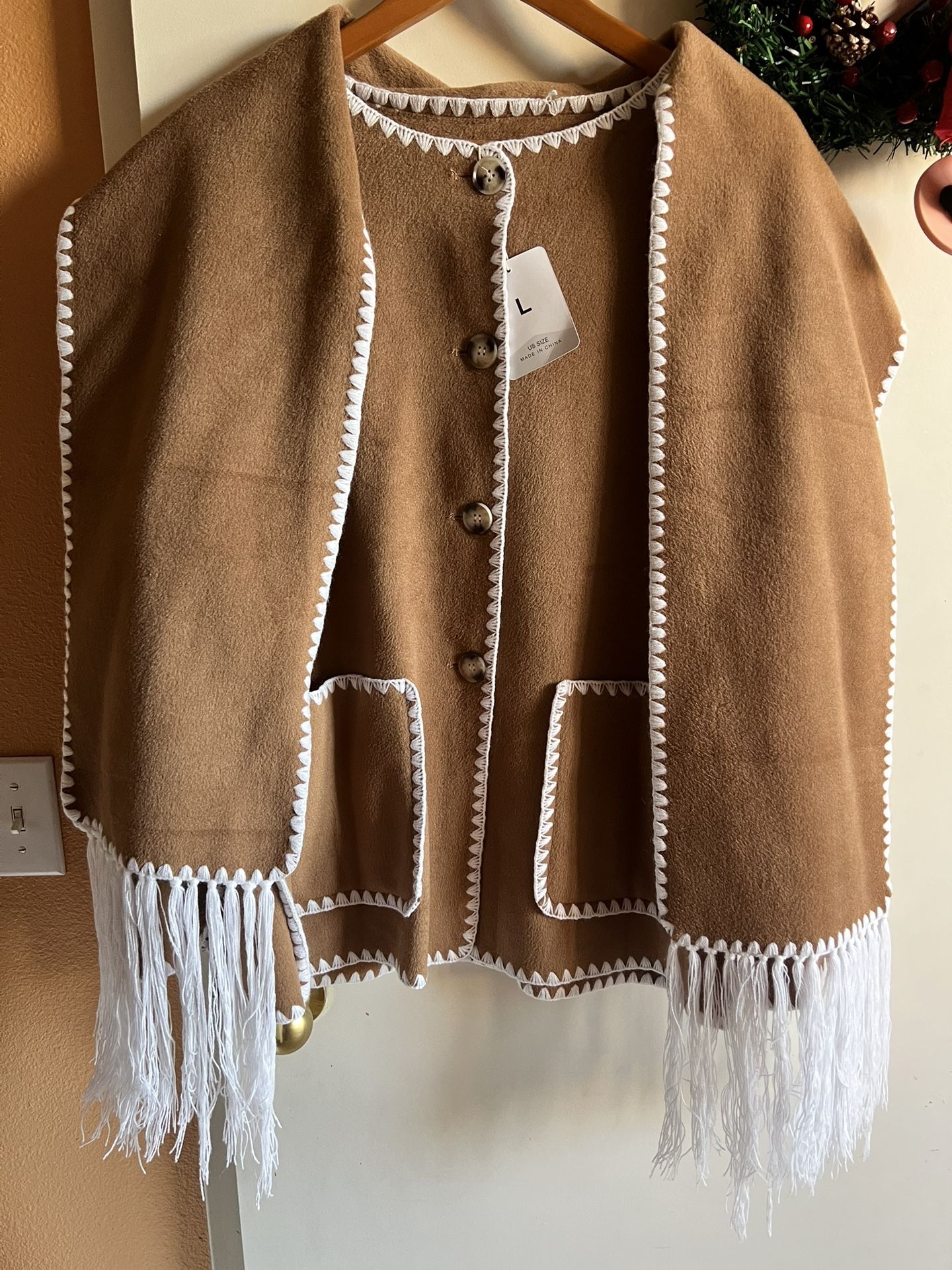 Camel Brown Fringe Coat with White Crochet Trim and Fringes. Features button closure and pockets. Will keep you warm. Great gift. Size L