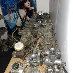 This is a collection of carburetors, devices used in older vehicles to mix air and fuel for the engine.