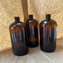 three new/unused amber glass boston round quart bottles