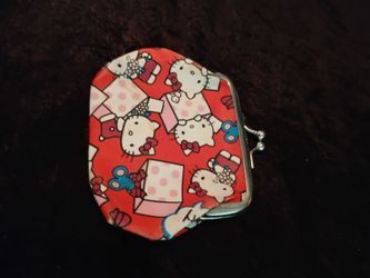 Hello Kitty themed mini change purse featuring a pink cartoon cat design with hearts and a ball clasp top $5.00