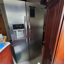 Stainless Steel Kitchen Appliances. Refrigerator, Dishwasher, And gas Stove