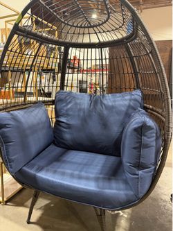 Oversized patio rattan egg lounge chair with blue cushions indoor or outdoor