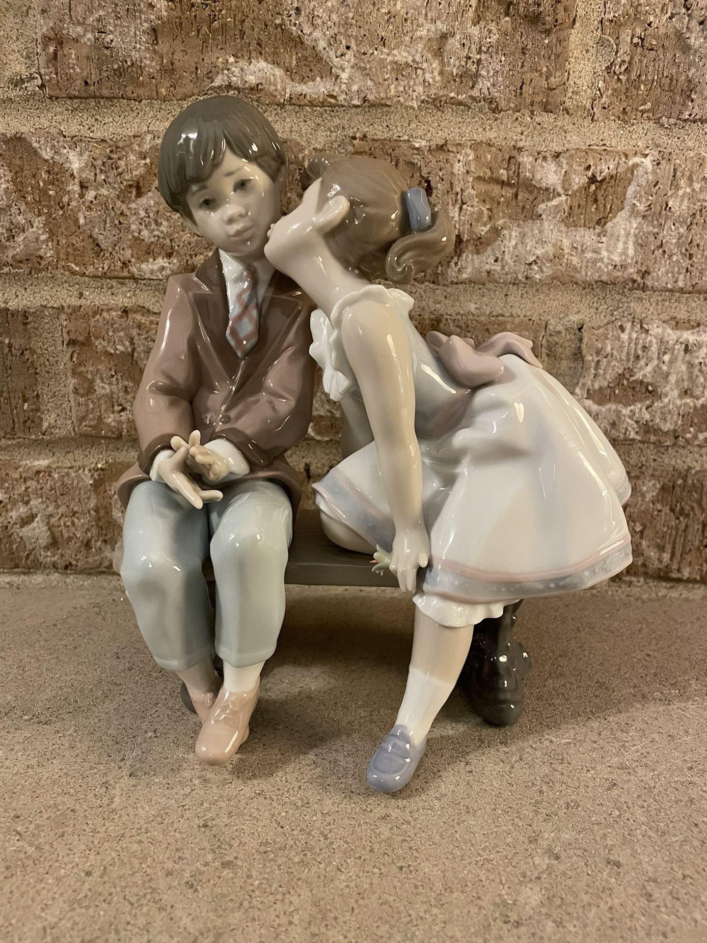 Lladro “Ten and Growing” Figurine 7635 girl giving a boy a kiss on bench