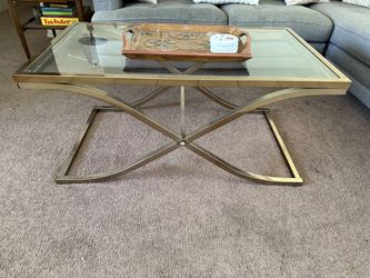 Glass-top coffee table with gold-tone base
