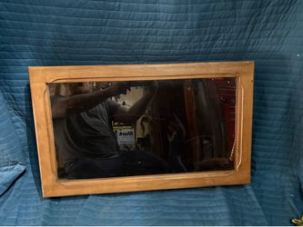 wooden display case with a glass door