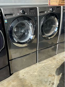 Graphite steel front load lg steam washer and front load lg steam dryer with pedestals  working perfectly with warranty extra for delivery same day de