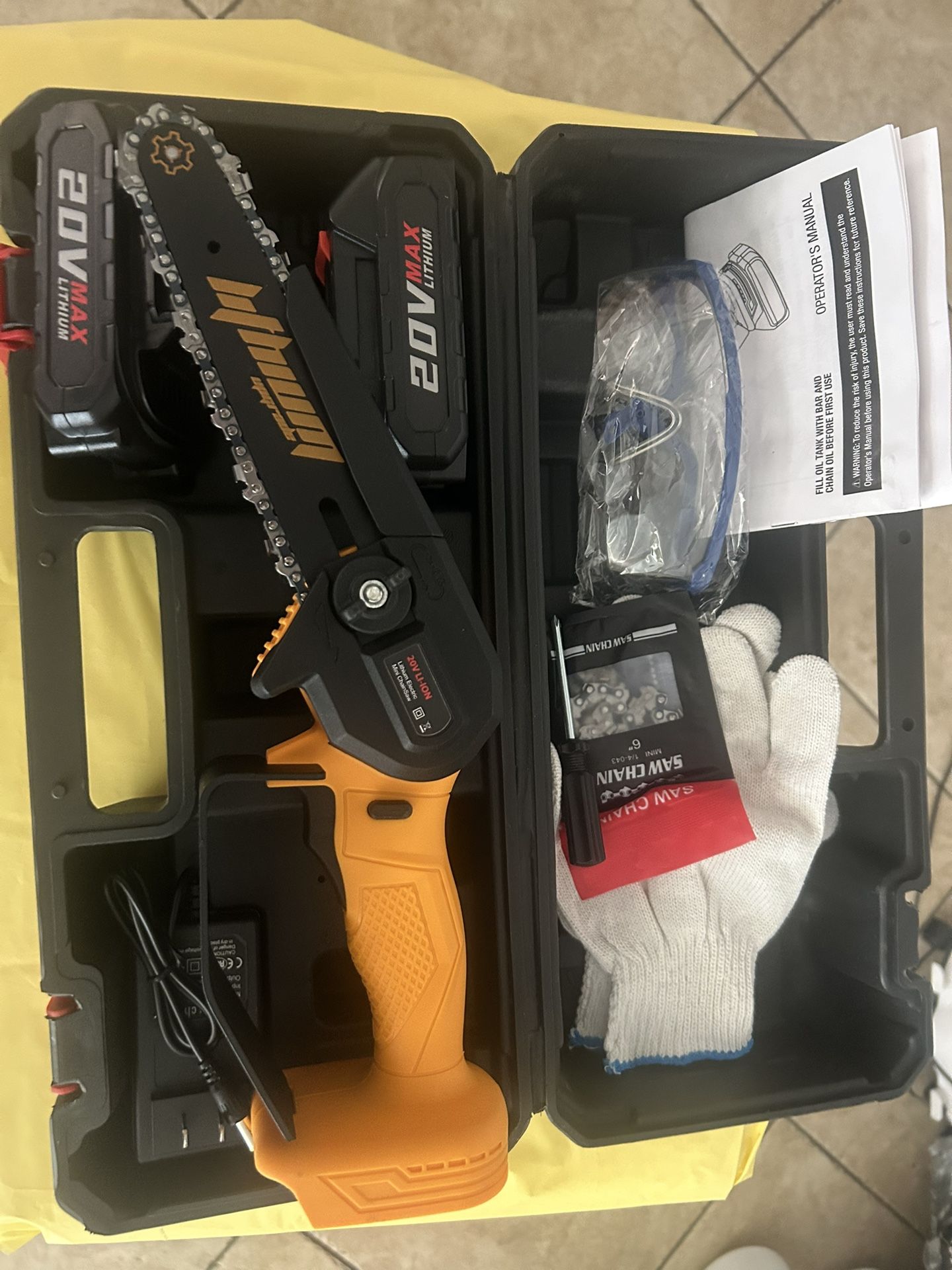 New 6 inch mini chainsaw it comes with two batteries, safety gloves, and safety glasses