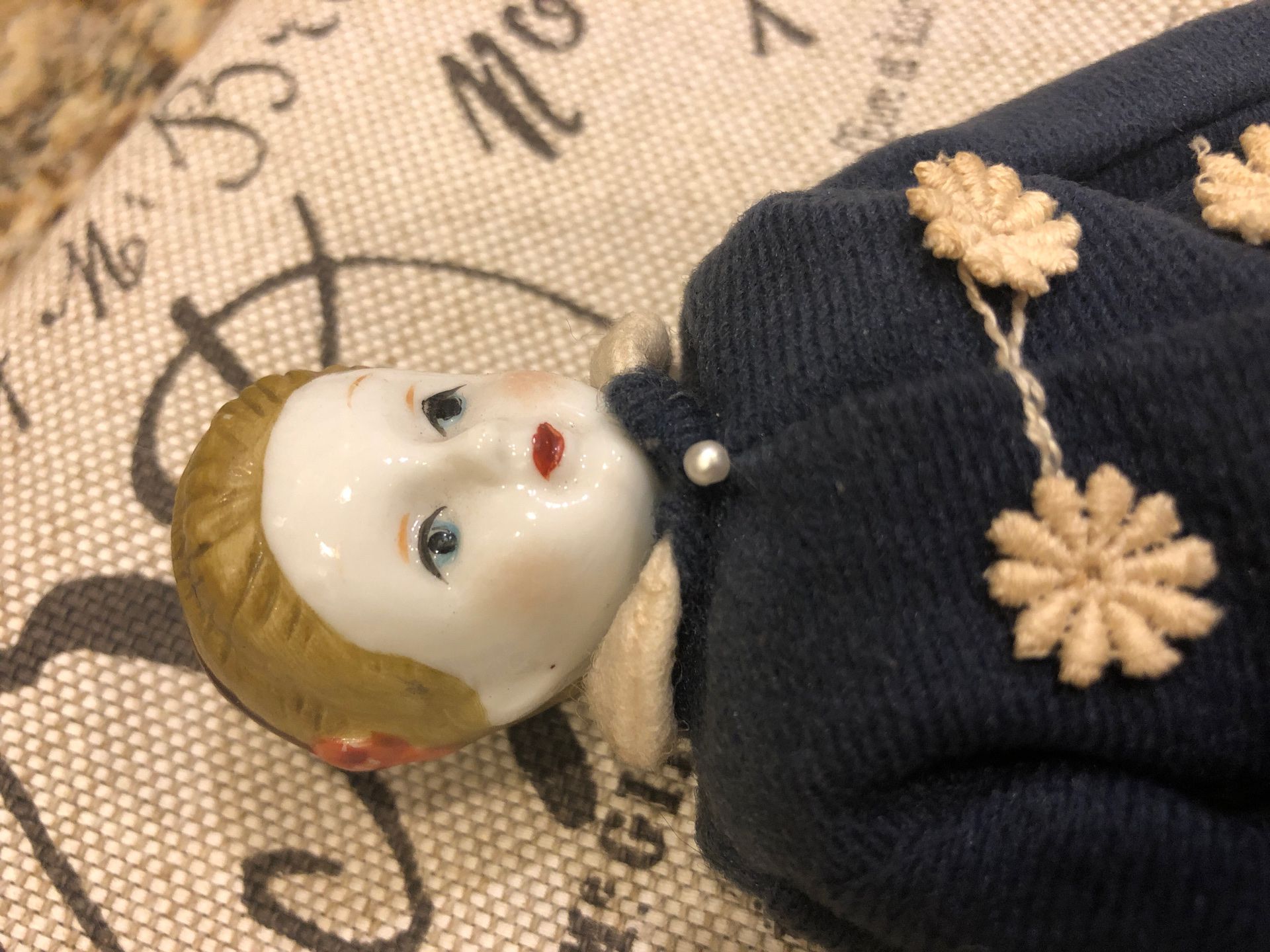 Antique doll in period clothing - porcelain