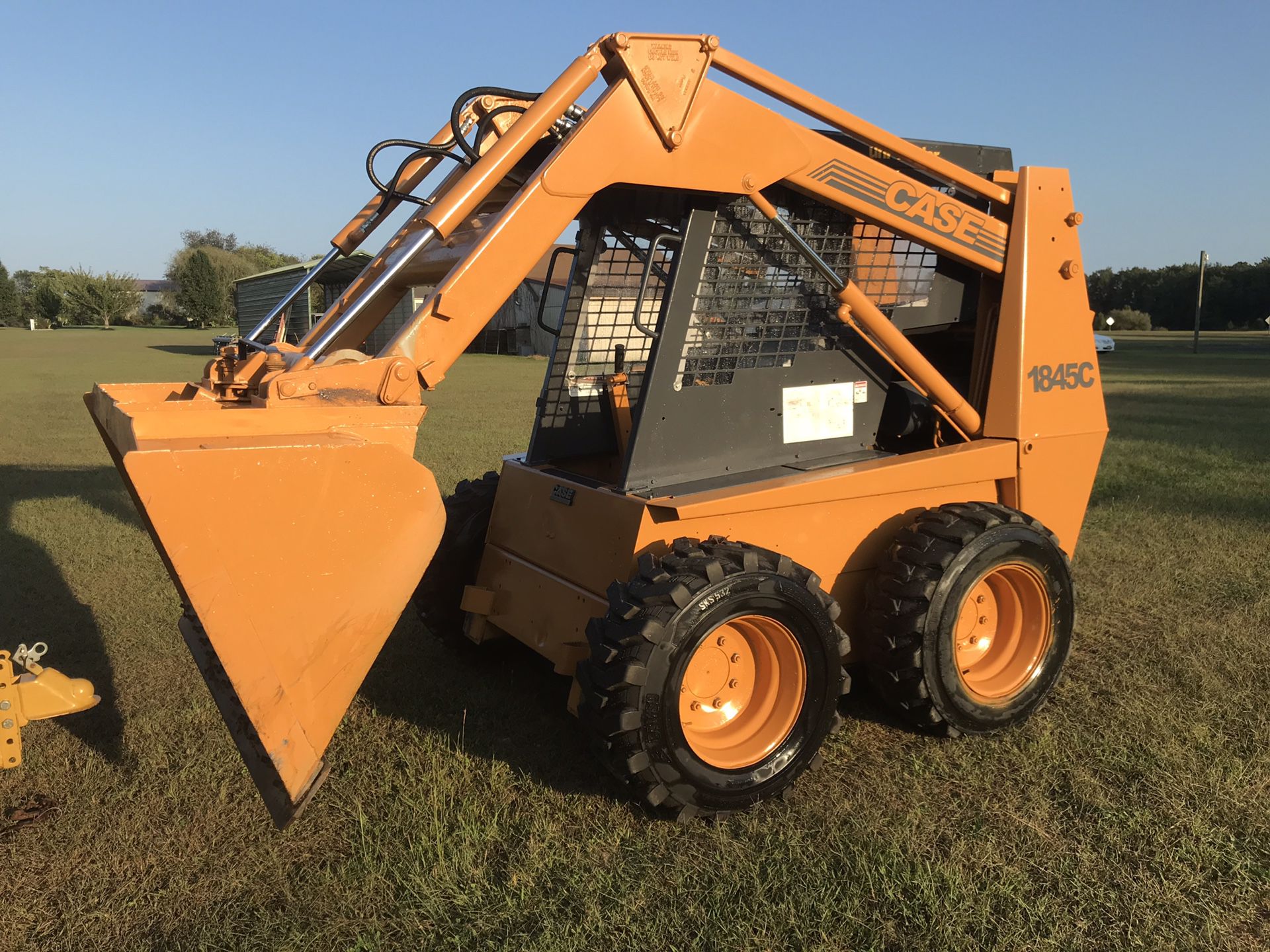 Case Skid Steer, Model 1845C w/ trailer and attachments