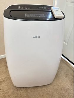 Quilo portable air conditioner, model QP112. Includes remote control and exhaust hose.