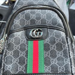Gucci,goes over chest dark gray and size is adjustable 