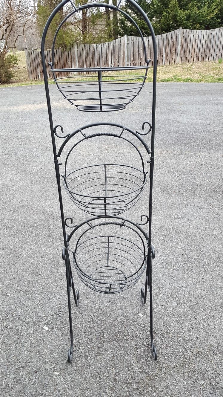 3 tier metal rack with wire baskets.