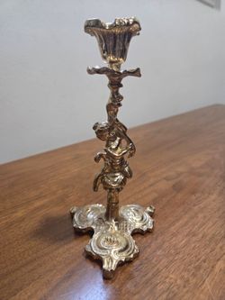 Ornate baroque figural brass candlestick