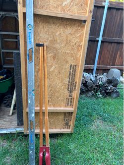 Post hole digger and 6 foot level