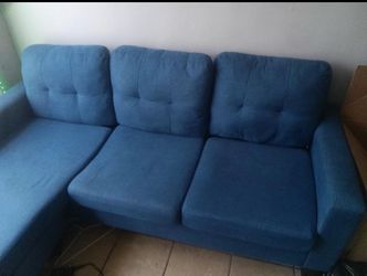 Small blue couch with chaise lounge