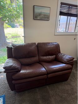 Brown ‘leather’ dual reclining loveseat 66”