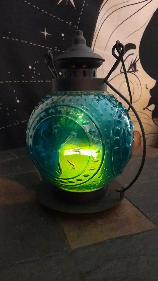 Pier 1 Vintage Candle Lantern The Glass Is Blue And The Frame Is Metal.